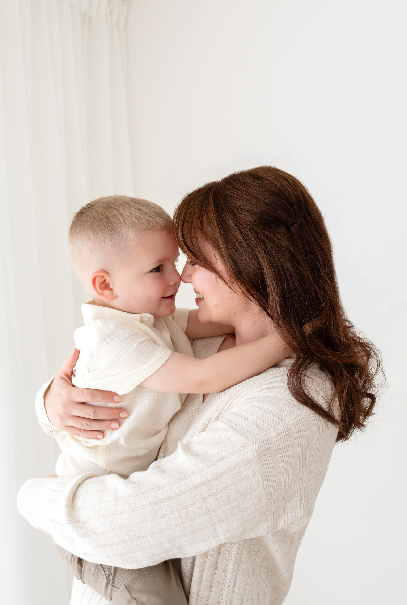 Young Mum with long dark hair having a cuddle with her young Son captured by Sutton Coldfield Family photographer Jo Hastings