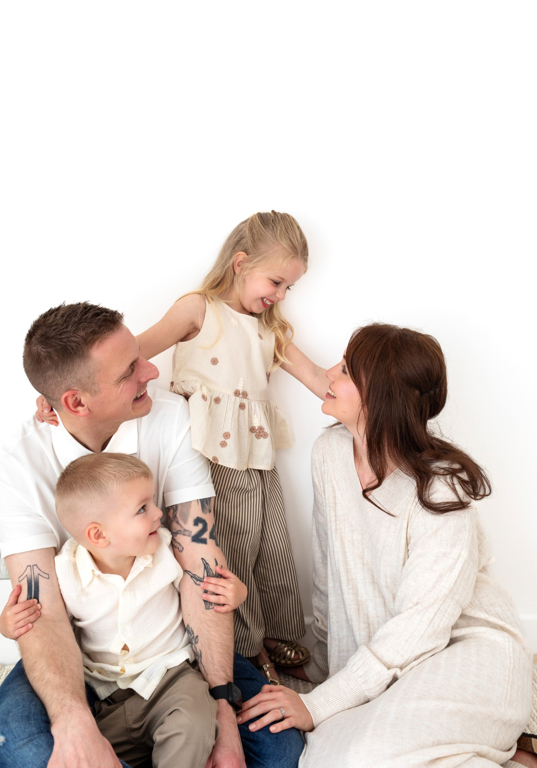 natural photo of a young family of four looking at each other during a family photography session