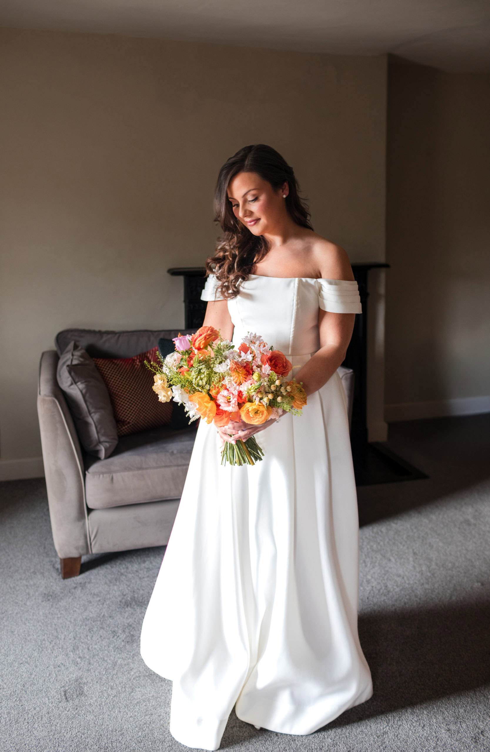 Modern editorial style portrait of a Bride holding a colourful bouquet at St Johns House in Lichfield