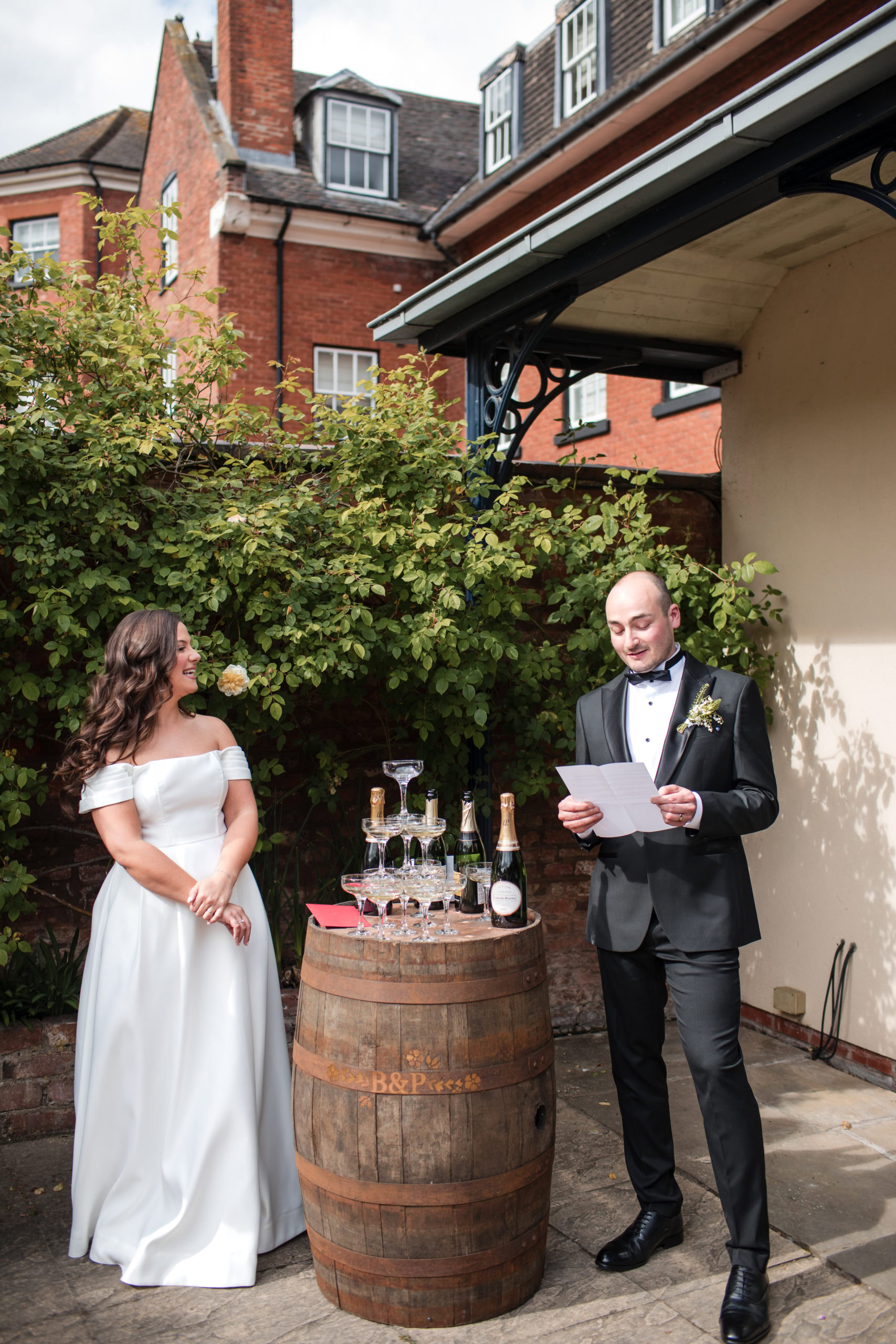 Outdoor speeches next to a champagne tower at wedding at St Johns House