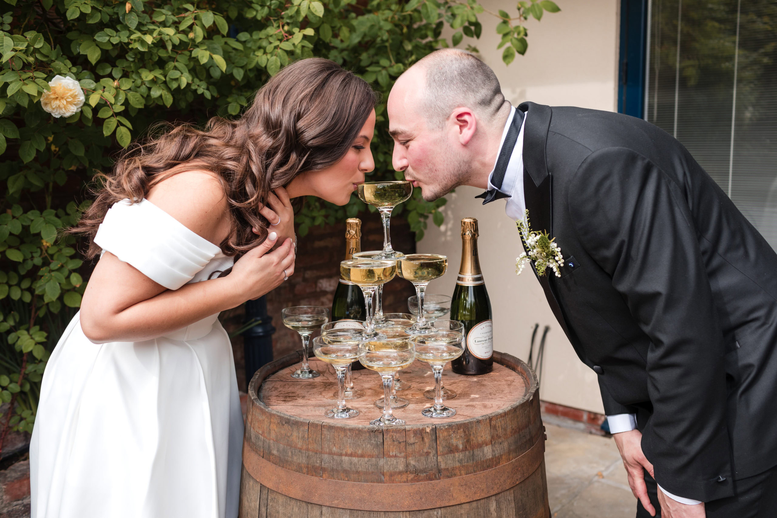 Fun photo of Bride and Groom drinking champagne from the same glass