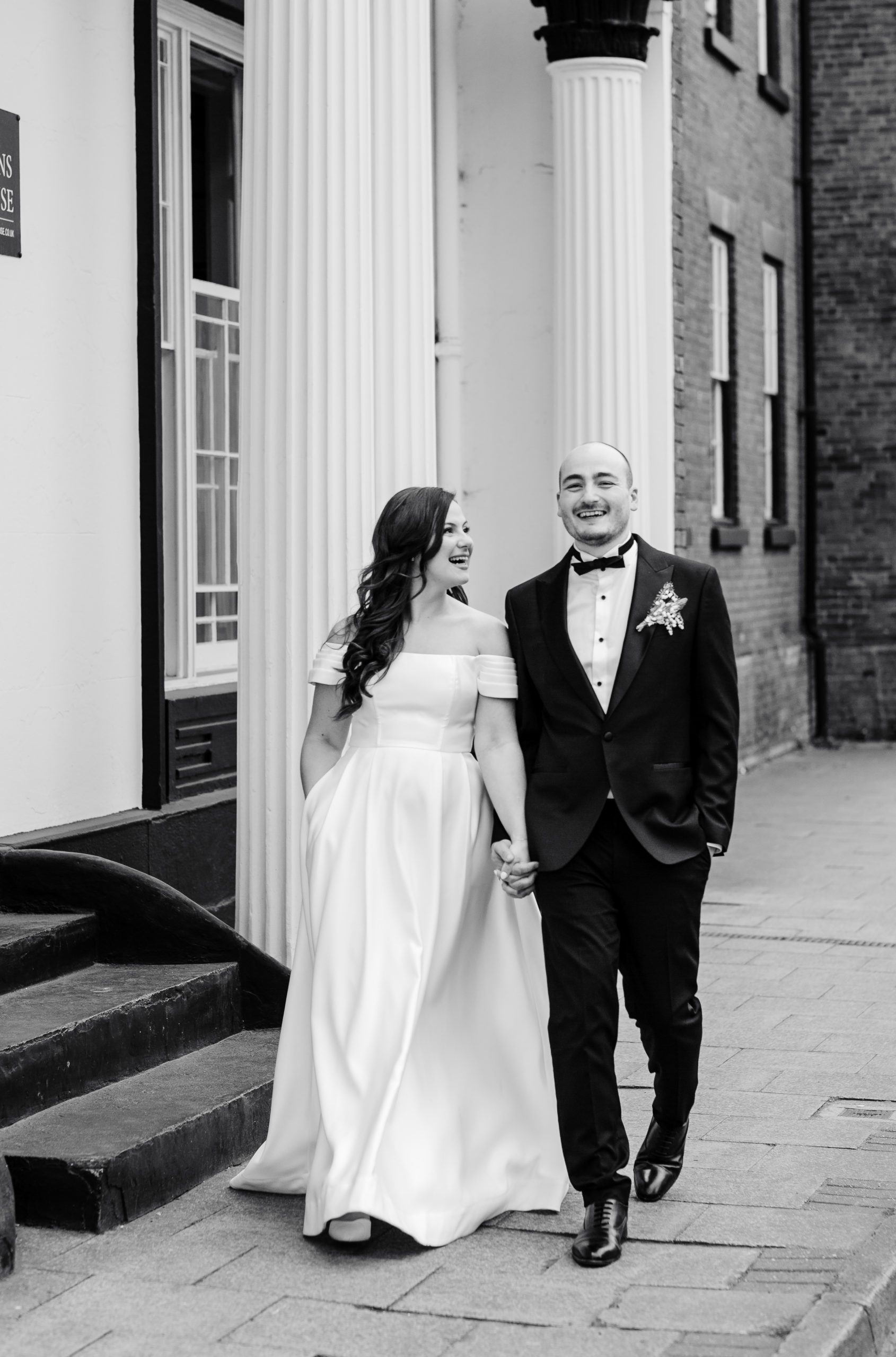 newly married couple hold hands and walk together in Lichfield